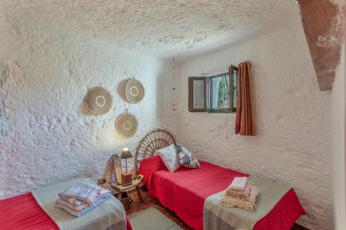 a bedroom with two beds and a window at Finca Cuevas La Solana in Gáldar