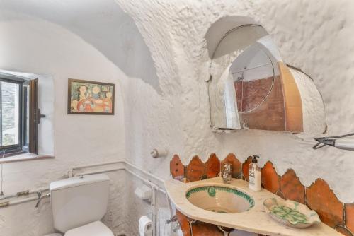 a bathroom with a sink and a toilet at Finca Cuevas La Solana in Gáldar