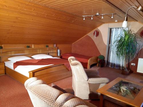 a bedroom with a bed and a table and chairs at Schwäbische Alb in Gomadingen