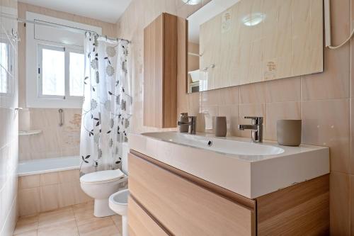 a bathroom with a sink and a toilet at Traditional Villa in Creixell