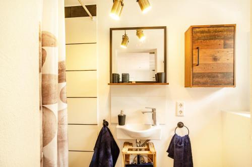 a bathroom with a sink and a mirror at Möwchen in Berumbur