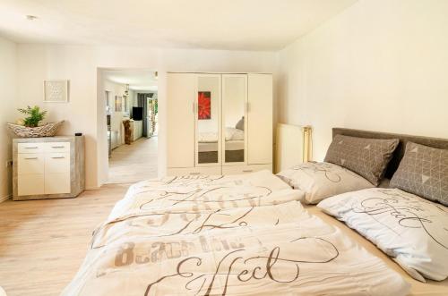 a large bed in a room with a bed sqor at Möwchen in Berumbur