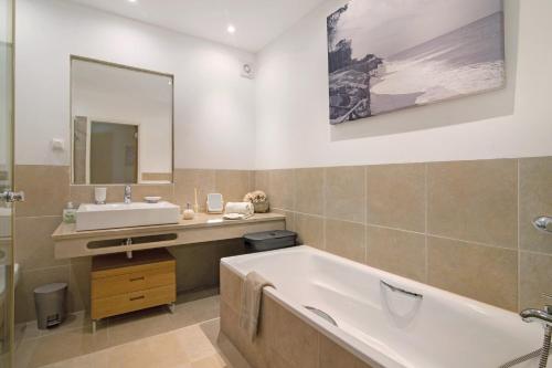 a bathroom with a tub and a sink at Villa Nicola in Vale do Lobo