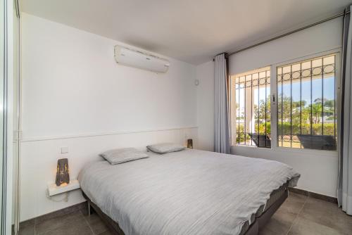 a bedroom with a bed and a large window at 2bed apartment in Miraflores in Mijas