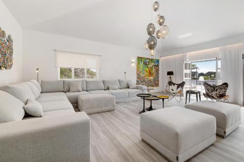 a living room with a couch and a table at Soltroia Beach Court -Heated Pool in Troia