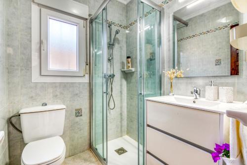 a bathroom with a shower and a toilet and a sink at El Horreo Xabia in El Tosalet