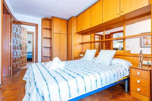 a bedroom with a large bed with wooden cabinets at Villa Monbijou in Vinarós