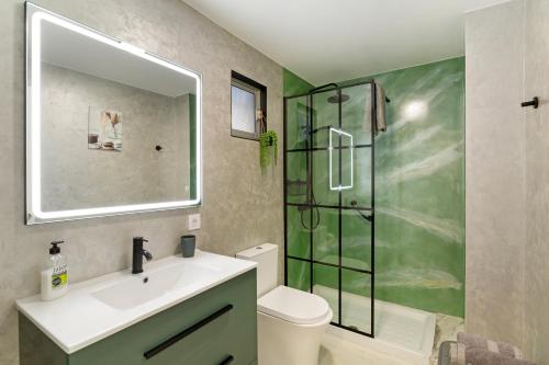 a bathroom with a sink and a glass shower at Kellys' Apartment Las Camelias in San Bartolomé