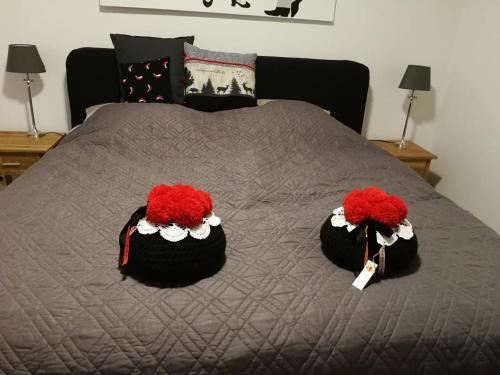 a bed with two red flowers on top of it at Ferienwohnung Gugel, 48qm in Kandern