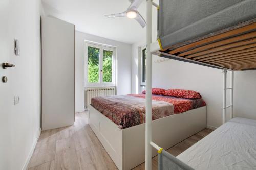 a bedroom with a bunk bed in a room at Ghome and Home Lake view Apartment in Civenna