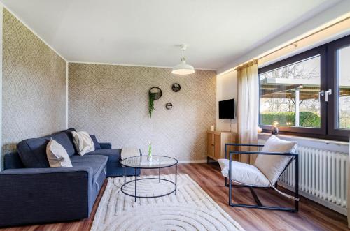 a living room with a blue couch and a table at Ferienwohnung Reichle in Stockach