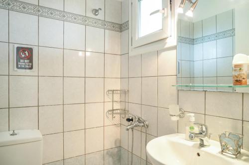 a bathroom with a toilet and a sink at Casa Miranda in Kefallonia
