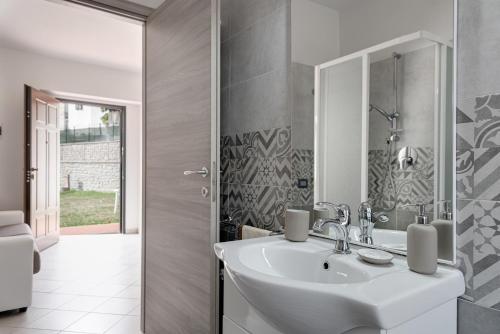 a bathroom with a sink and a mirror at Chalet La Greta con vista in Firenzuola