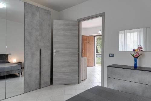 a bedroom with a pivot door with a mirror at Chalet La Greta con vista in Firenzuola