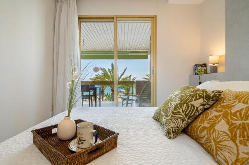 a bedroom with a bed with a tray with a vase on it at Apartamento Pelicano in Cambrils