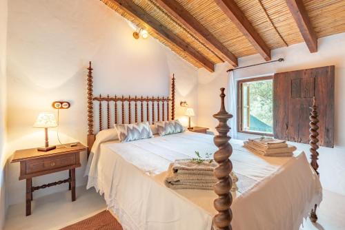 a bedroom with a large bed and a window at Villa Cami de la Mar in Port de Soller