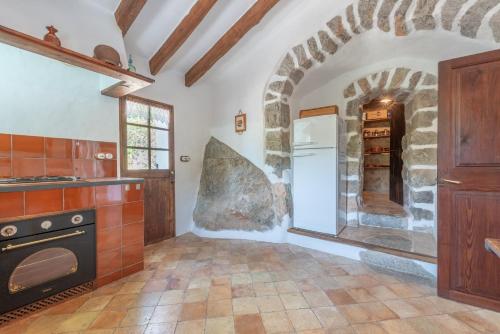 a kitchen with a stove and a refrigerator at Villa Cami de la Mar in Port de Soller