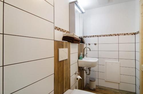 a bathroom with a toilet and a sink at Albpartments in Meßstetten