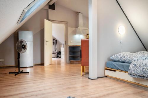 a small attic bedroom with a bed and a hallway at Zum Kanal in Steinau