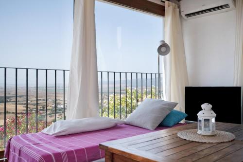 a bedroom with a bed and a large window at Casa De Los Pintores Facinas in Facinas