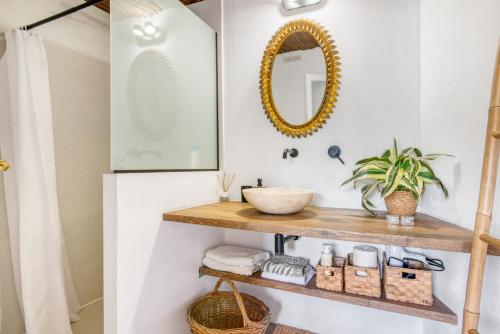 a bathroom with a wooden shelf and a mirror at Ca la Pasita 28 in Beniali