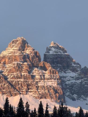 a large rocky mountain with snow on it at Alla Vecchia Dogana in Misurina