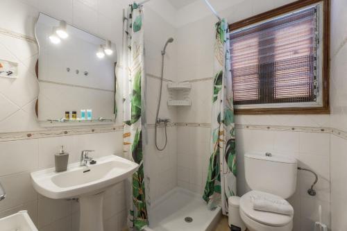 a white bathroom with a sink and a toilet at Casa Palmar La Gomera in Valle Gran Rey