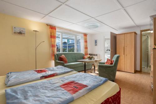 a hotel room with two beds and a living room at Ferienbungalows Werner in Koserow