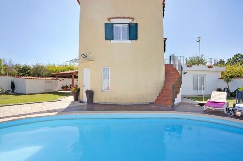 a villa with a swimming pool in front of a house at Moinho de Paradela in Paradela