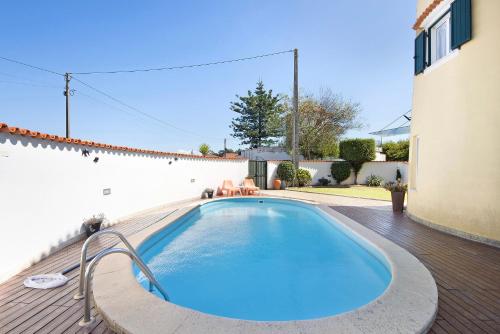 a swimming pool on a deck next to a house at Moinho de Paradela in Paradela