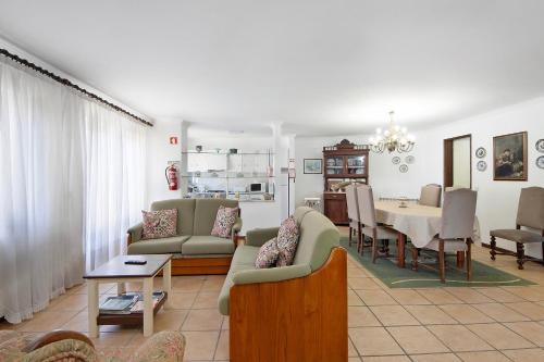 a living room with a table and a dining room at Moinho de Paradela in Paradela