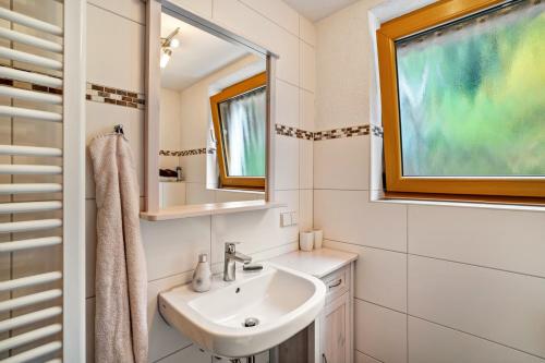 a bathroom with a sink and a window at Ferienwohnung Graf in Lauf