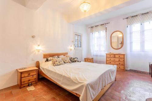 a bedroom with a large bed and a mirror at Maison Collo in Collobrières