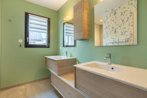 a bathroom with a large sink and two mirrors at Paradi Bleu in Trégunc