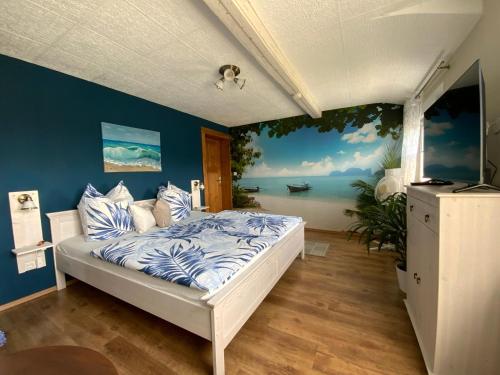 a bedroom with a bed with a painting on the wall at Haus Steffine in Annahütte