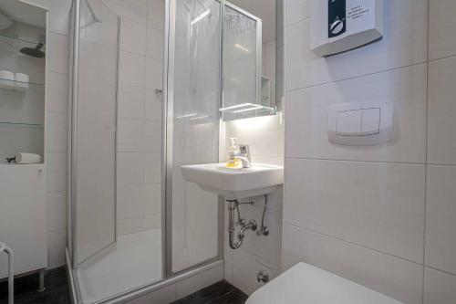 a bathroom with a toilet and a sink and a shower at Ferienhaus Klaus in Berumbur