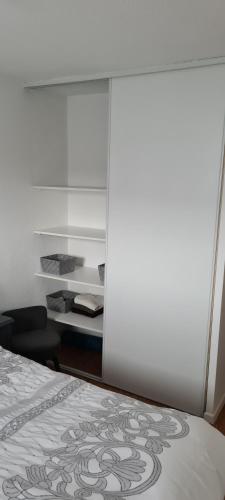 a bedroom with a bed and a chair and a desk at Balcons Du Soleil -Conciergerieland in Saint-Paul-lès-Dax