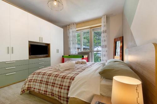 a bedroom with a large bed and a tv at Residenza Tambella in Verrès
