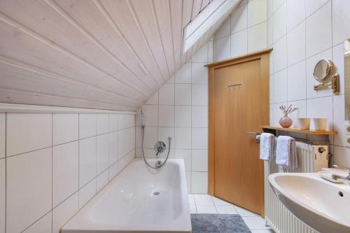 a bathroom with a tub and a sink at Ferienwohnung an der Brigach in Donaueschingen