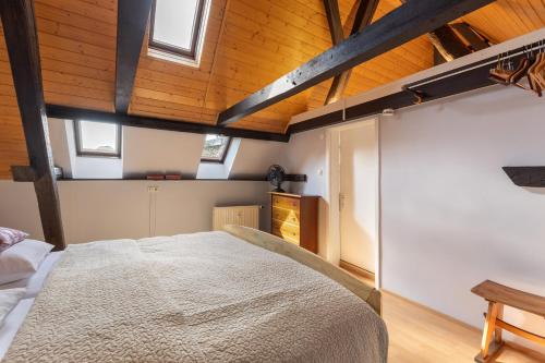 a bedroom with a large bed and wooden ceilings at Ferienwohnung an der Brigach in Donaueschingen