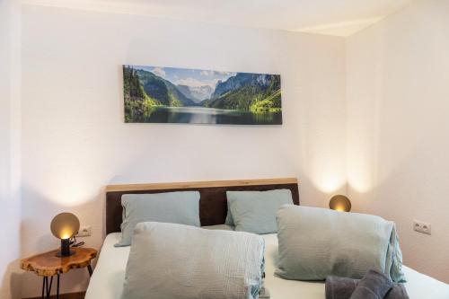 a bedroom with a bed with a picture on the wall at Apart Celina in Oetz