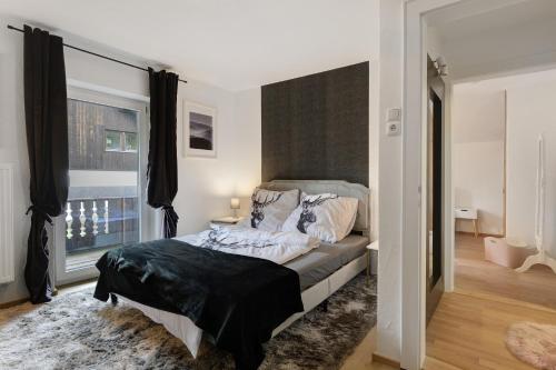 a bedroom with a bed and a large window at Haus Rübezahl in Bayerisch Gmain