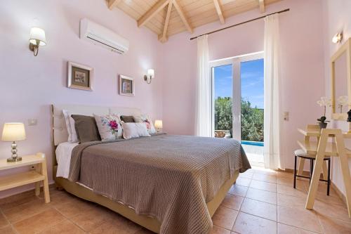 a bedroom with a bed and a large window at Villa Belvedere Rosa in Lefkada