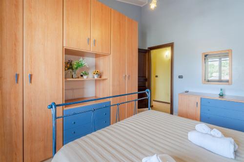 a bedroom with a bed and wooden cabinets at Villa Raffa in Avola