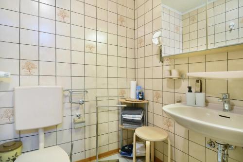a bathroom with a toilet and a sink at Eifelferienhaus Thome Lissendorf in Lissendorf