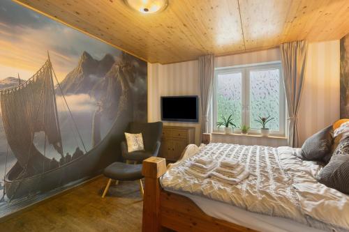 a bedroom with a large painting on the wall at Ferienwohnung Haus Luise in Olsberg