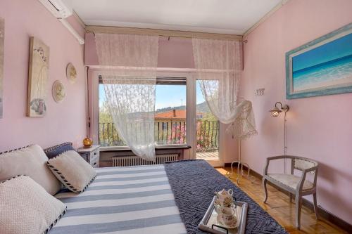 a bedroom with a bed and a large window at Ca dei Tati -Citr 1181 with Jacuzzi in Imperia