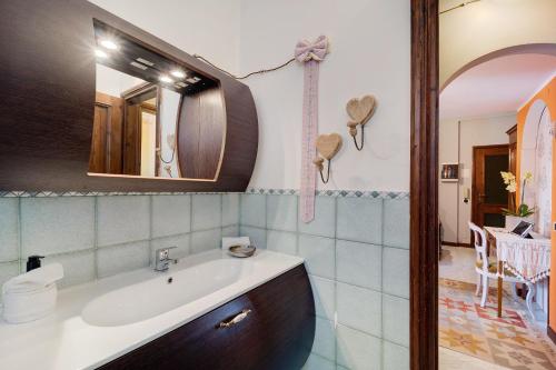 a bathroom with a sink and a mirror at Ca dei Tati -Citr 1181 with Jacuzzi in Imperia