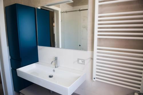 a bathroom with a white sink and a mirror at Casa di Olly in Sona