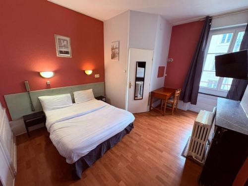 a bedroom with a bed in a room with red walls at Hotel de l'Academie Place Stanislas, Nancy Centre , Gare et Congrés in Nancy